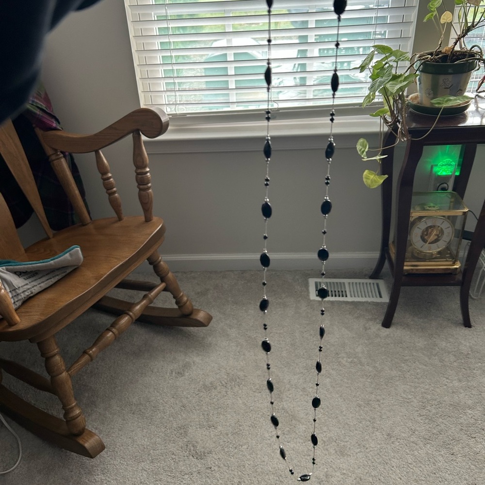 64 inch necklace with 2 1/3 inch extender. Costume jewelry, not real silver.